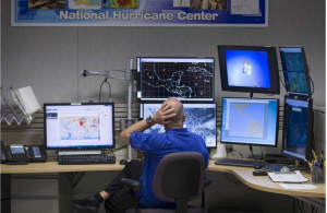 picture shown on houston chronicle op-ed showing person in front of several computer screens monitoring a storm
